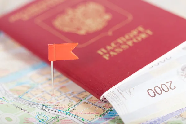 Passport with money lies on the tourist map