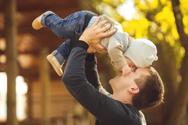 Father and her child enjoy the summer in the park. Outdoors.