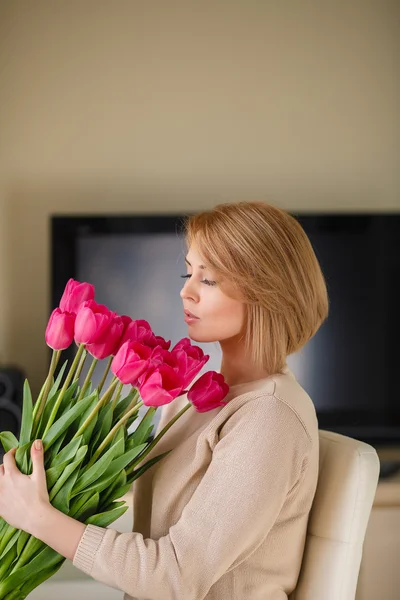 Bright pink flowers in girl's hands.