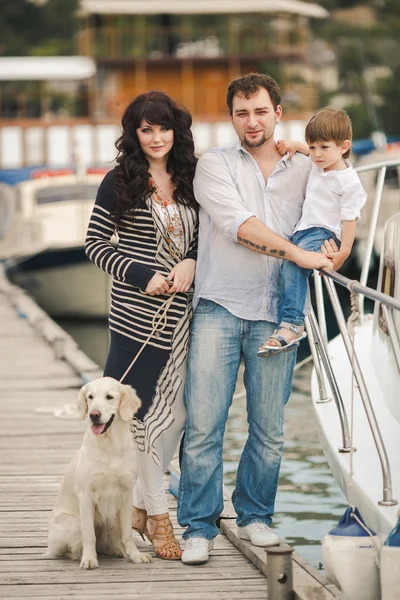 Happy family with dogs on the Quay in the summer