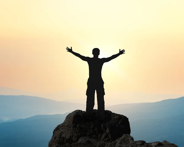 Man on top of mountain.