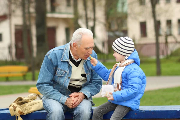 Grandfather and grandson eating