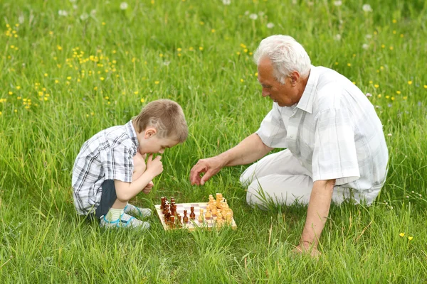 Grandfather and grandson playing chess