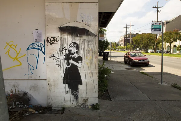 Girl with an umbrella. Graffiti by Banksy in New Orleans