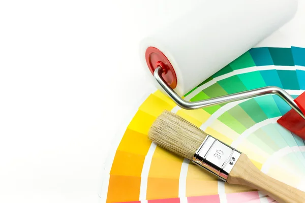 Paint roller and brush over color swatches