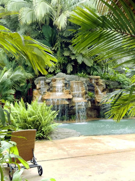 Swimming pool with a waterfall and hot thermal water