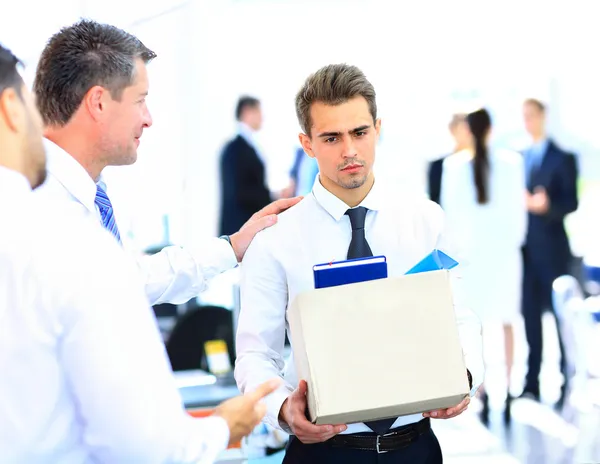 Dismissed businessman carrying box