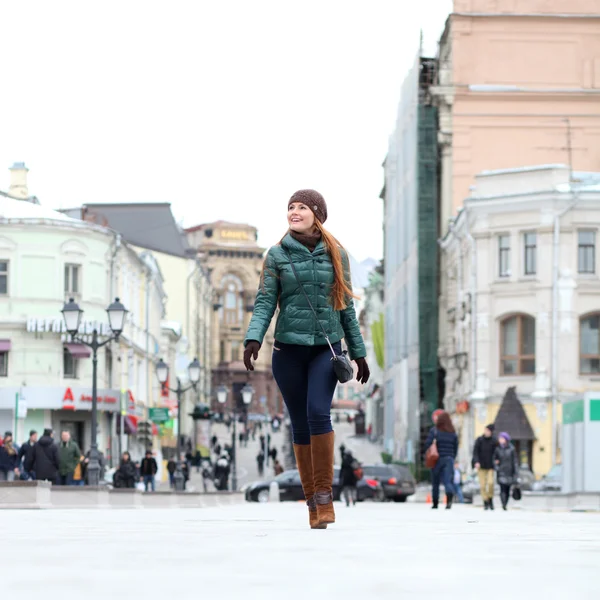 Walking woman in autumn Moscow street