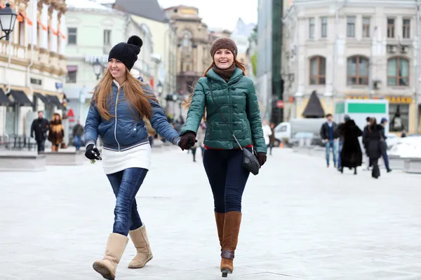 Happy young couple women in winter street