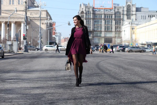 Walking woman in autumn Moscow street