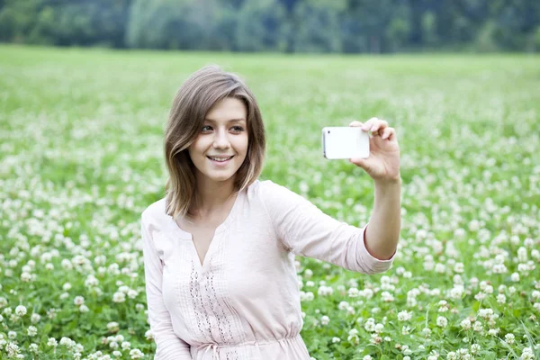 Young woman taking pictures on your phone