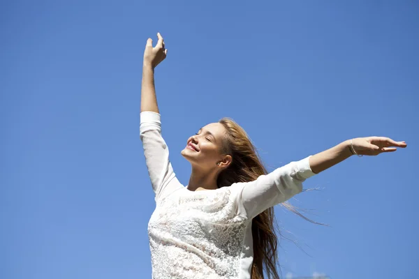 Upwards view of young woman enjoying life