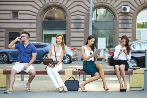 Business people sitting on a bench