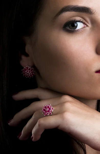 Beautiful woman with silver ruby ring and earrings