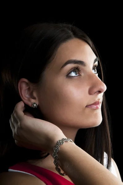 Woman with silver earrings and bracelet