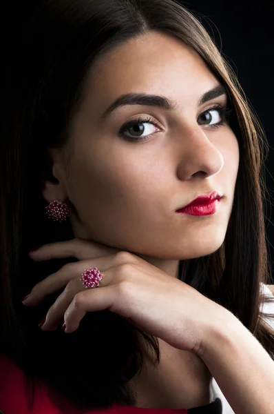 Young woman with silver ruby ring and earrings