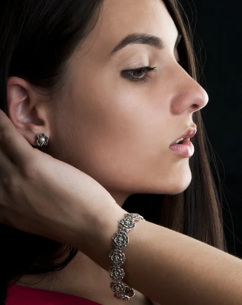 Woman with silver bracelet and earrings