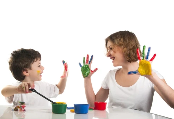 Happy mother and her son having fun with paints