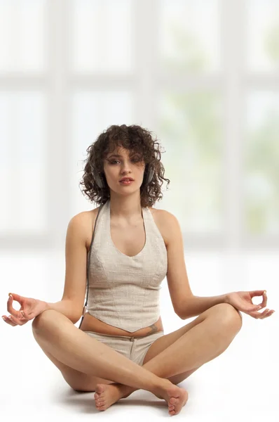 Woman meditating with music in Easy yoga Pose