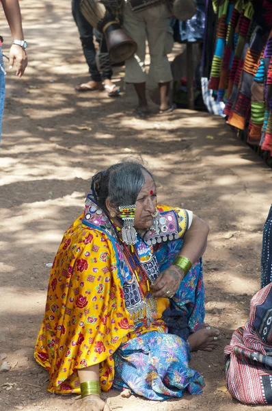 Indian woman offering people to buy her goods on the Mandrem market