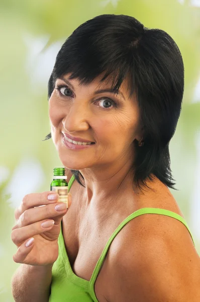 Mature woman with essential oil