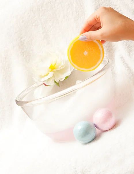 Elegance woman hand holds soap - orange.