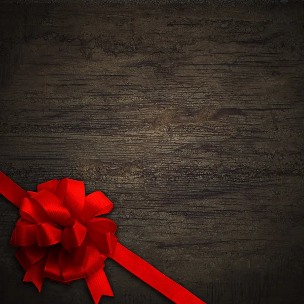 Red bow on black wall wood texture