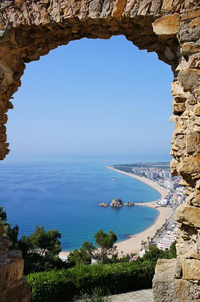 Beach Blanes view through arch. Costa Brava, Catalonia, Spain