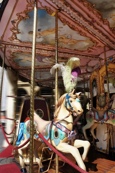 Horse rides on a merry-go-round carousel