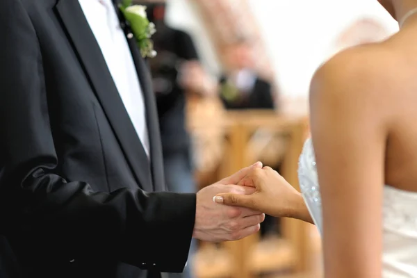 Bride and groom holding each other\'s hands