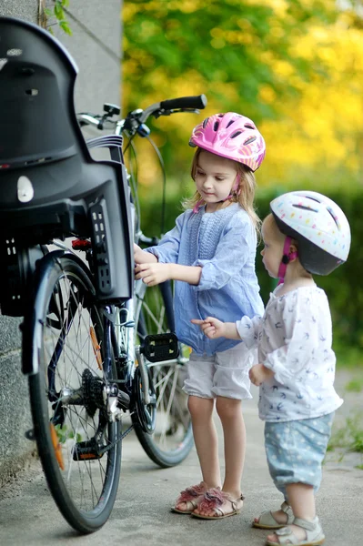 Two sisters going to have a bicycle ride
