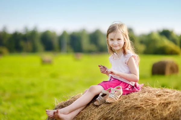 Adorable girl in wheat field