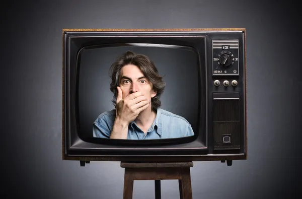 Scared man in old TV screen.