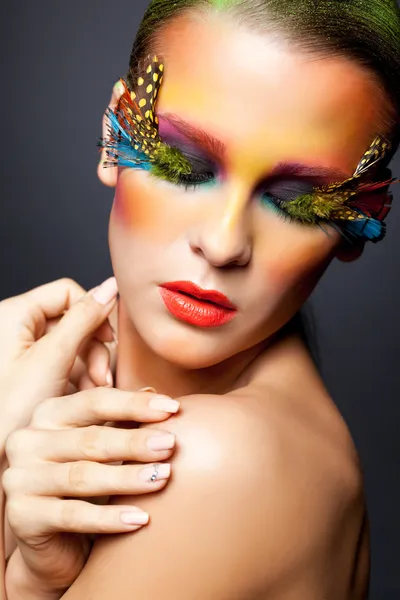 Woman with false feather eyelashes makeup