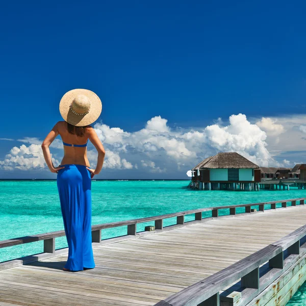 Woman on a beach jetty at Maldives