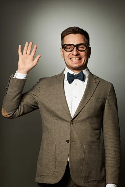 Nerd in eyeglasses and bow tie says Hello