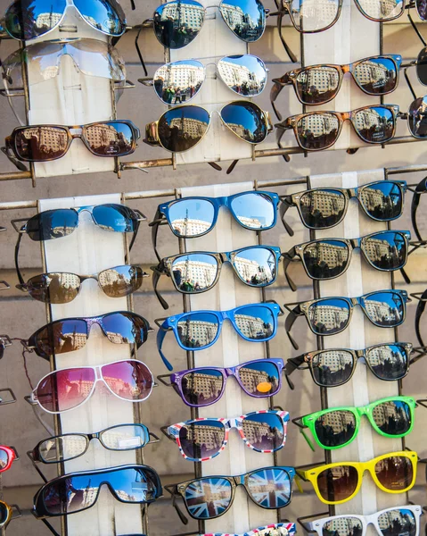Many sunglasses on display in shop — Stock Photo #21213725