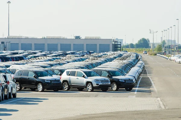 TUSCANY, ITALY - 27 June: New cars parked at distribution center