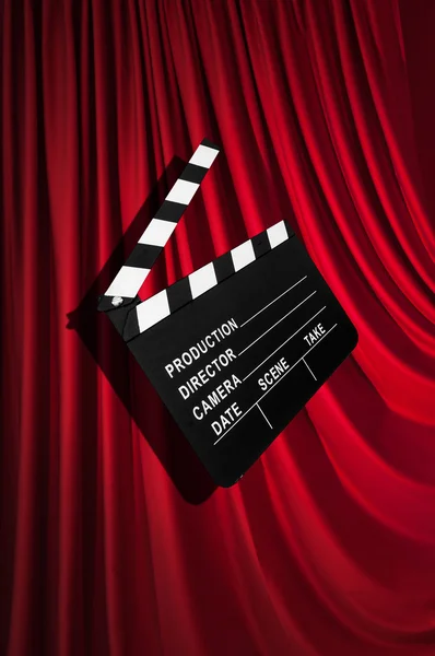 movie clapper board against curtain