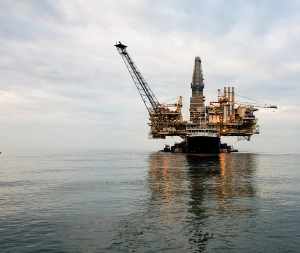 Oil rig being tugged in the sea