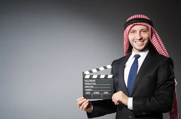 Arab man with movie clapper