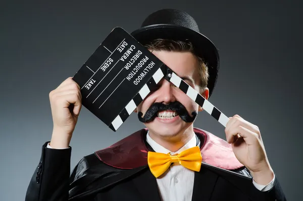 Man with movie clapper board