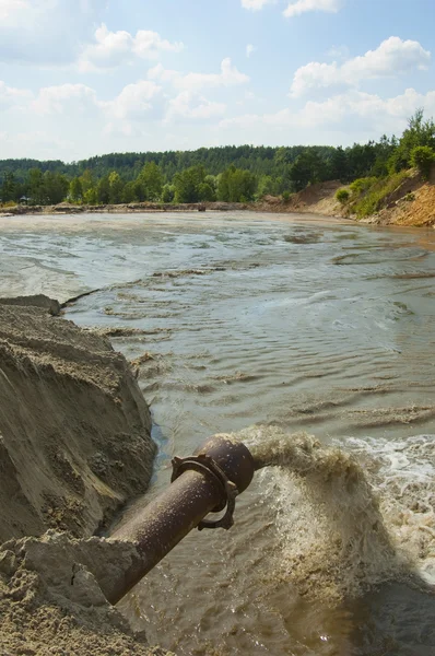 Dirty water flows from a pipe.