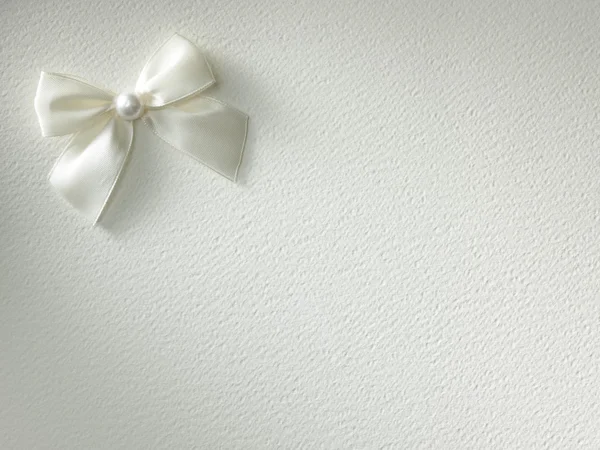 White ribbon with bow on a background