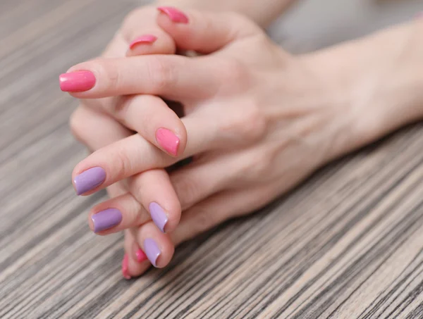 Women\'s hands with a colored nail polish