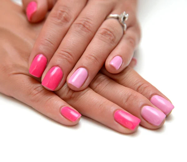 Women\'s hands with a colored pink nail polish