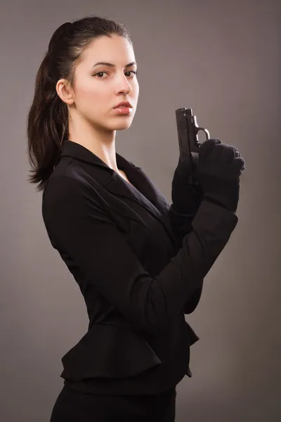 Spy girl in a black with gun