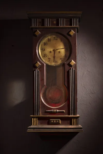 Grandfather clock hanging on a wall