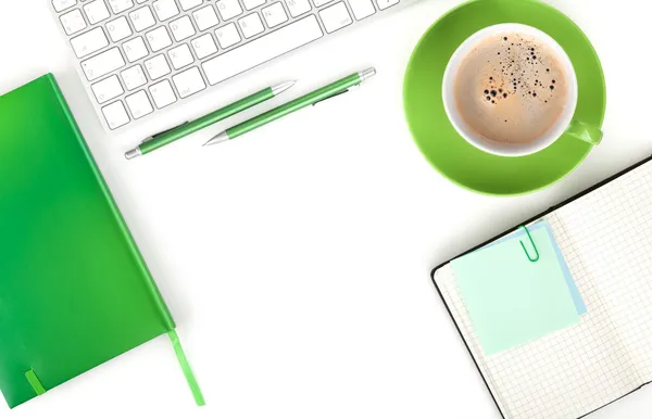 Green coffee cup and office supplies