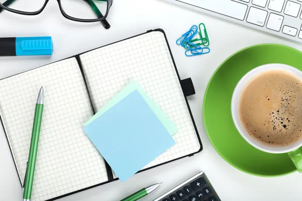 Green coffee cup and office supplies